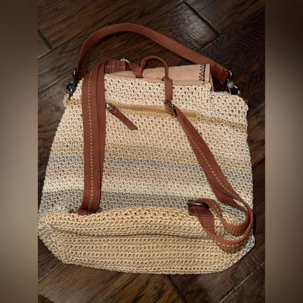 The Sak Crochet Straw Backpack in green and Cream with Brown Trim